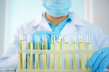 Doctor examining the urine in laboratory, closeup