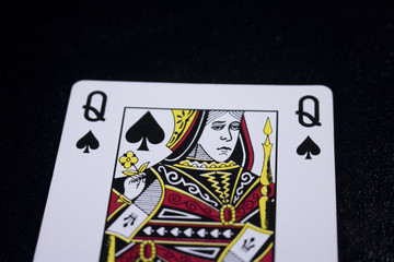 queen poker card on dark black background