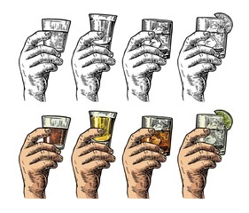 Male hand holding a glasses with tequila, rum, whiskey and ice cubes.