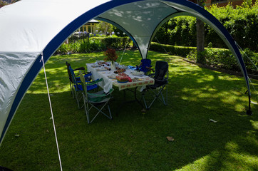 Summer lunch table under a gazebo tent