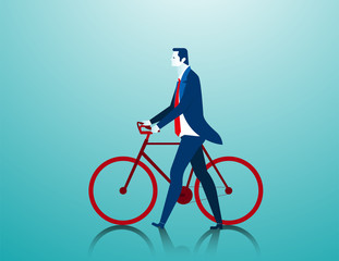 Businessman pushing a bicycle while going to work