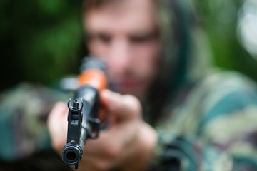 Armed soldier in camouflage with a Kalashnikov assault rifle, so