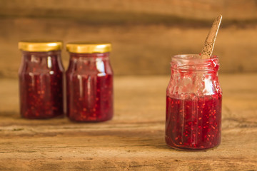 Homemade jam with raspberry on the wooden table