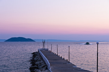 Pier and turtle island in a background, near the city of Neos Marmaros, Sithonia, Greece
