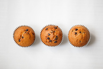 Small biscuit cupcake with chocolate on a light background. Flat lay

