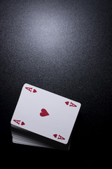 Obraz premium poker card stack deck on dark black background