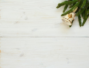 Christmas tree branches with christmas decorations on white wood