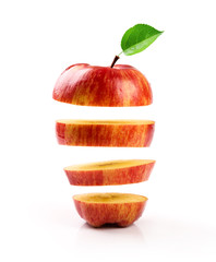 sliced red apple levitating on white background