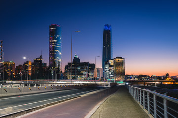 Beautiful view to road and illuminated skyscrapers in Santiago, Chile. Horizontal outdoors shot
