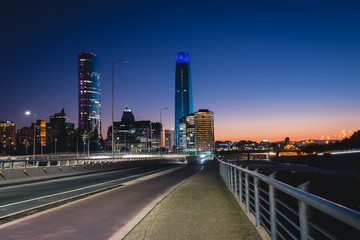 Beautiful view to road and illuminated skyscrapers in Santiago, Chile. Horizontal outdoors shot