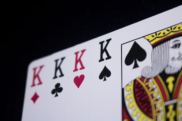 four of a kind king poker card on dark black background