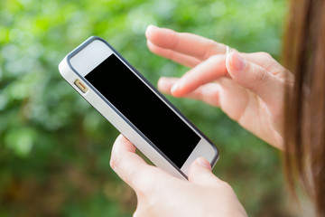 Hand of women using mobile smart phone with blank white screen