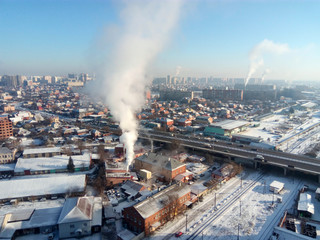 Winter town. Frosty sunny day in the city. Snow on the streets and smoke from the boiler rises. Frost and sun, a wonderful day
