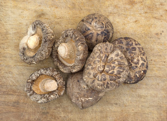 Dried mushrooms on a wood cutting board.