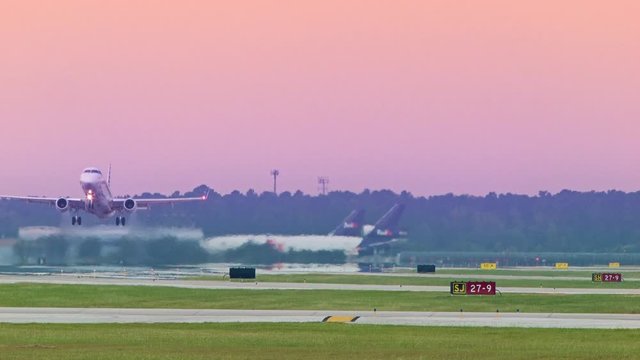 Commercial Jet Airliner Taking Off into a Vibrant Colored Sky at Houston George Bush Intercontinental Airport IAH