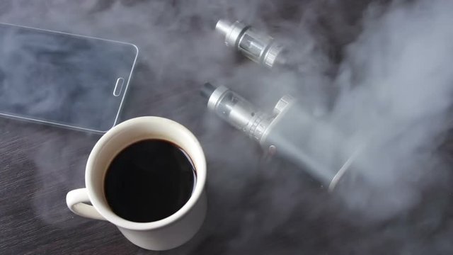 businessman with an e-cigarette on the stylish table