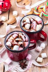 Hot chocolate with marshmallows and spices on christmas table