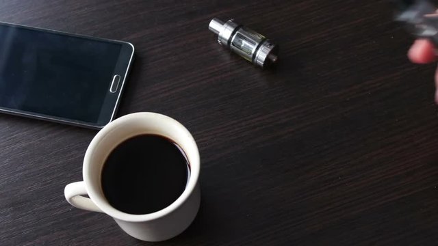 businessman with an e-cigarette on the stylish table