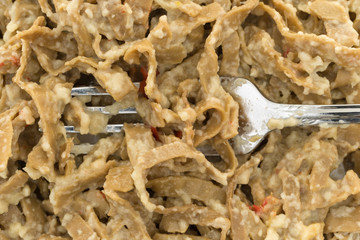 Close view of edamame fettuccine with a fork.