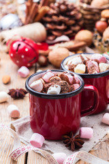 Hot chocolate with marshmallows and spices on christmas table