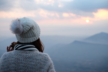 woman looking for sunrise with mountain background