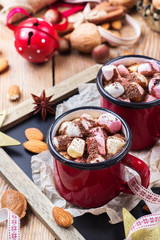 Hot chocolate with marshmallows and spices on christmas table