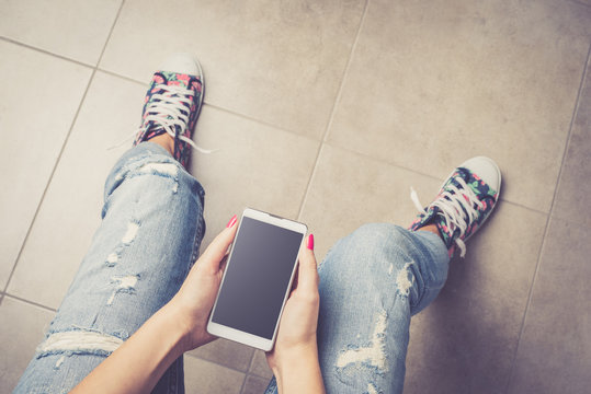 Overhead Shot Of Woman Holding Smart Phone