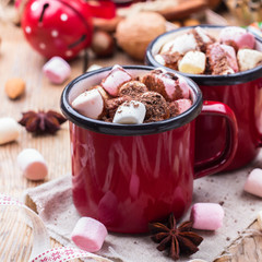 Hot chocolate with marshmallows and spices on christmas table