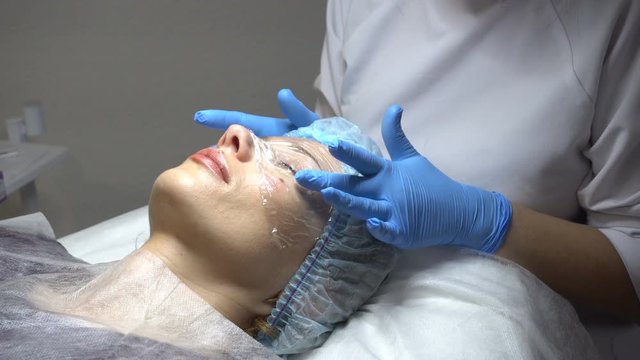 Young woman getting treatment in beauty saloon