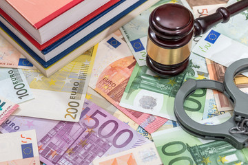 handcuffs with hammer of judge and euro. business concept