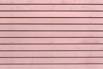 Rows of red painted clapboard siding