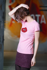 Tricky girl posing in pink shirt with print