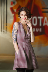 Fototapeta premium Happy smiling girl posing in square dress without sleeve