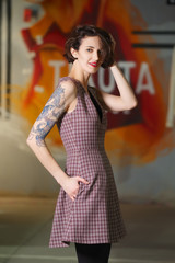 Happy smiling girl posing in square dress without sleeve