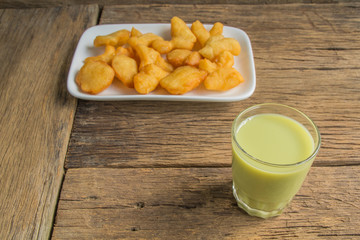 green soybean milk and deep-fried doughstick on wood background