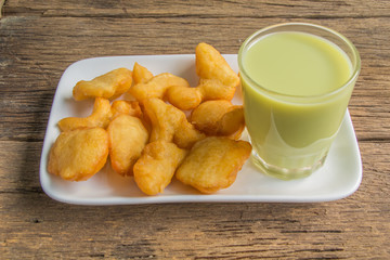 green soybean milk and deep-fried doughstick on wood background