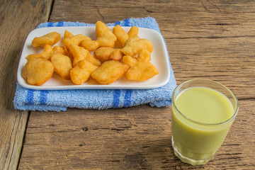green soybean milk and deep-fried doughstick on wood background