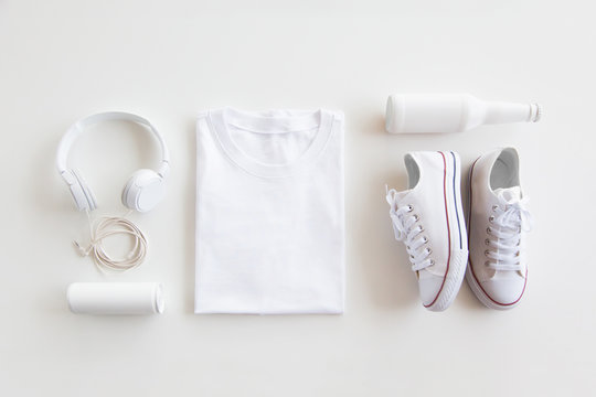 Fototapeta Blank stuff on white background. Template for design presentations. Branding Mock-Up. Shirt, sneakers, headphones, bottle.