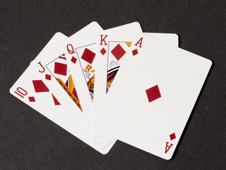 Royal flush of diamonds on black canvas