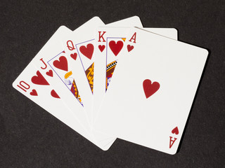 Royal flush of hearts on black canvas