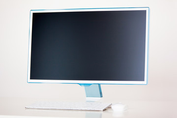 Desktop computer with wireless keyboard and mouse on white background. Branding Mock-Up.