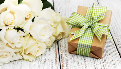 White roses and gift box