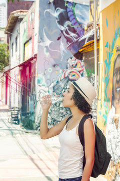 Girl hydrates in a summer day