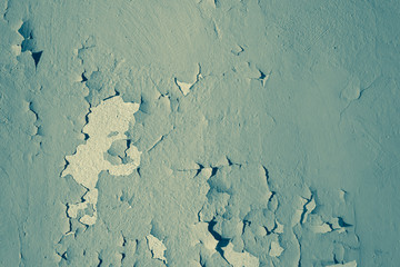 Turquoise. Natural background. Wall with a shabby and peeling paint and plaster. Contrast and volume.