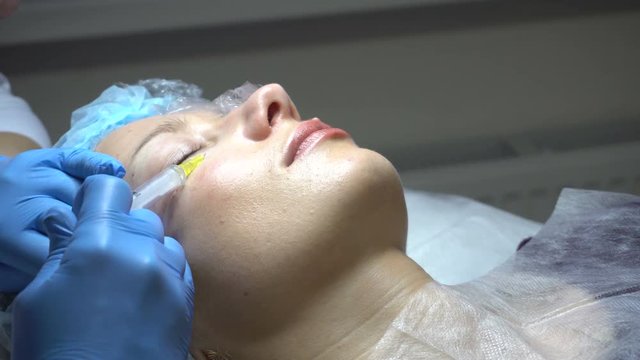 Young woman getting treatment in beauty saloon