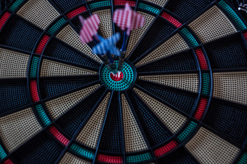 Three darts in the center of a target close up