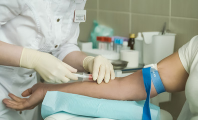 Nurse taking donor's blood from patient