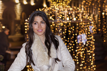 beautiful sad woman alone on the street on new year.Night outdoor scene