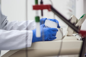 Modern scientist working in biotechnological laboratory equipmen