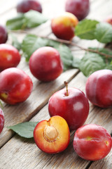 Fototapeta na wymiar Fresh plums on a grey wooden table
